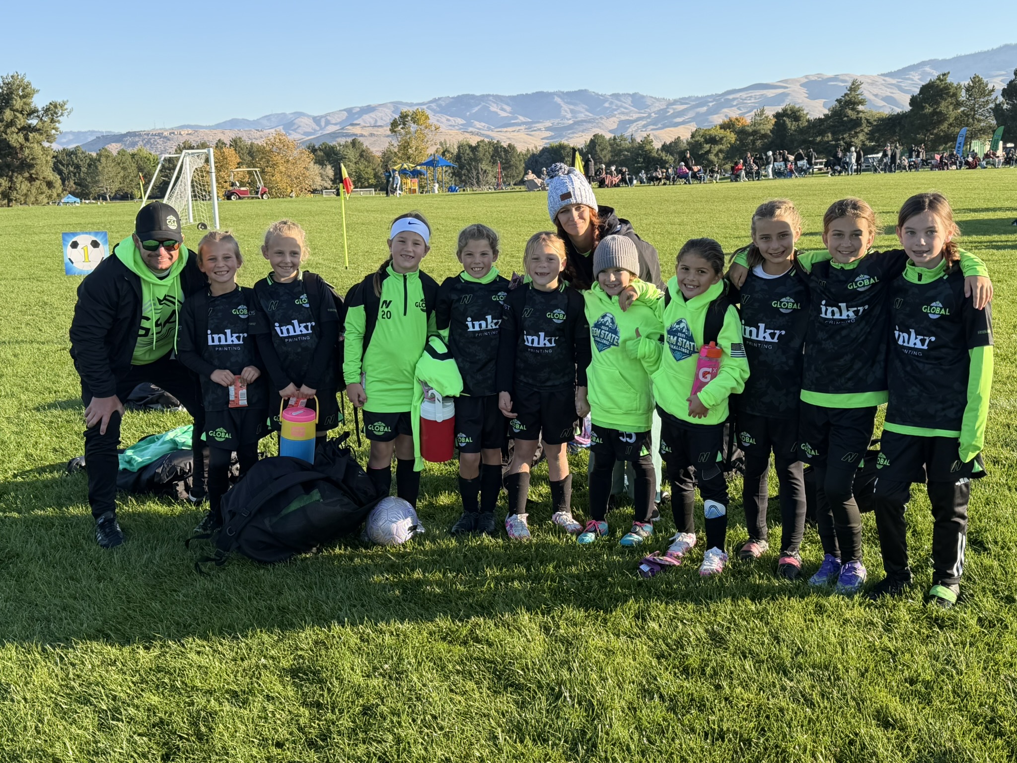 Grace's team photo with mountains in the background