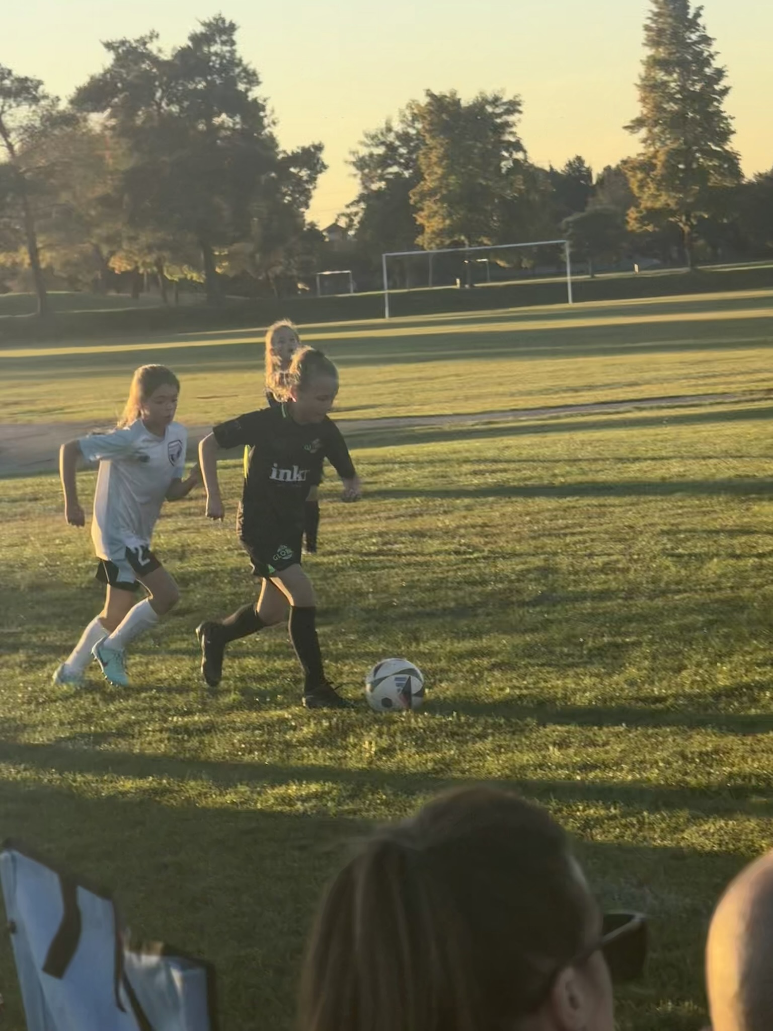Grace in a sunset action shot on the soccer field