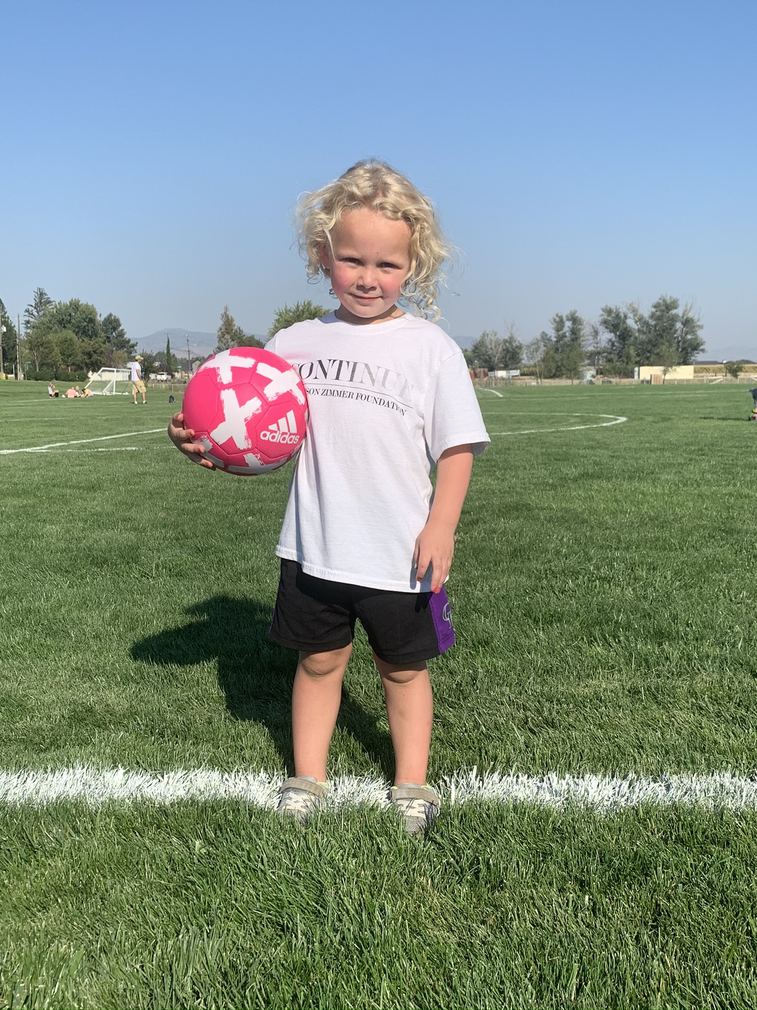 Young Grace with her first pink soccer ball